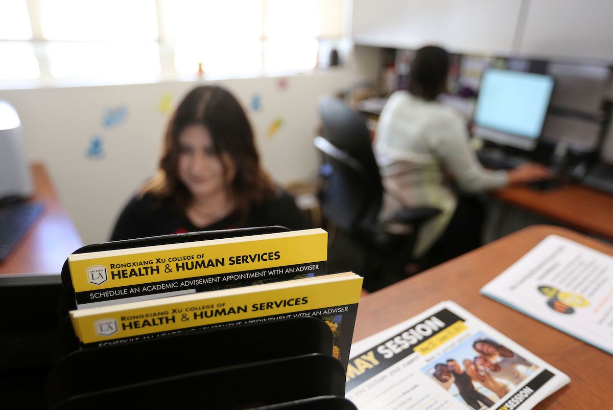 Student working the front office of the advising center