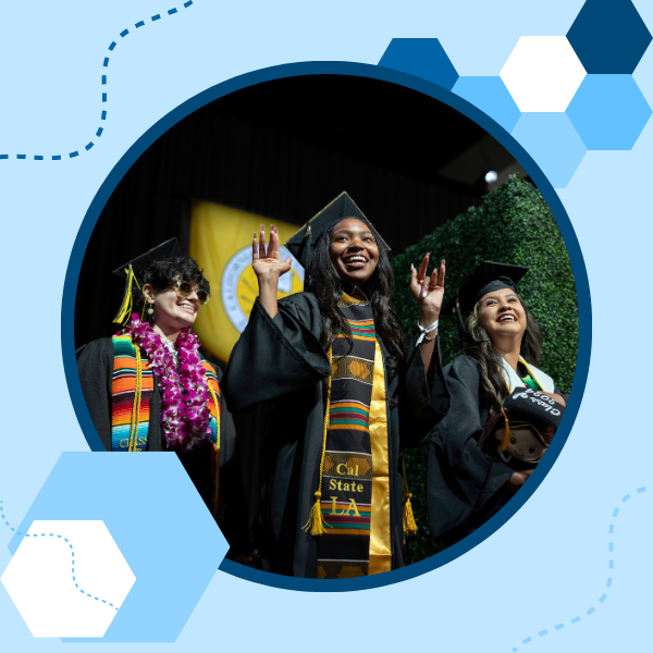 Three graduates smiling besides each other with the one in the middle waving with both hands