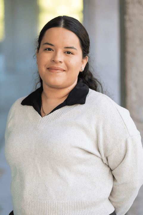 A person with long black hair, smiling