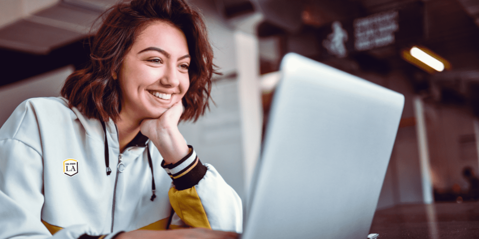 Female student takes online class via her laptop.