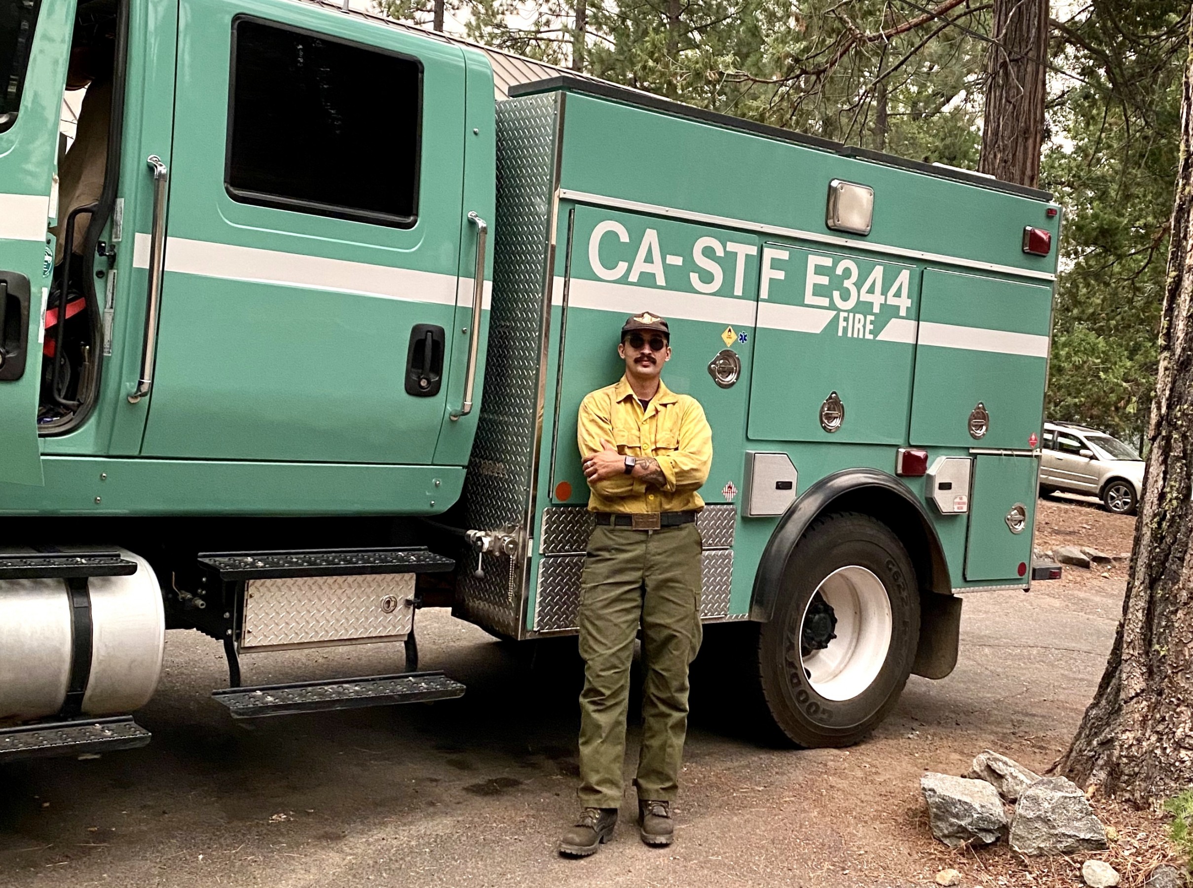 Anthony Galvez in front of a firefighting vehicle