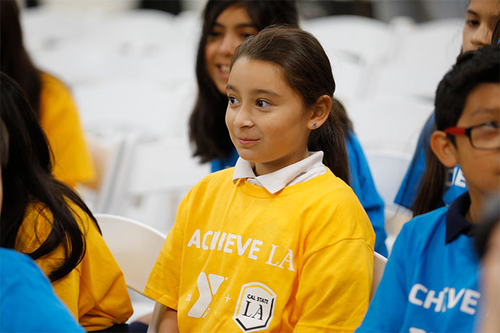 Elementary students sitting in the audience with Achieve LA shirts