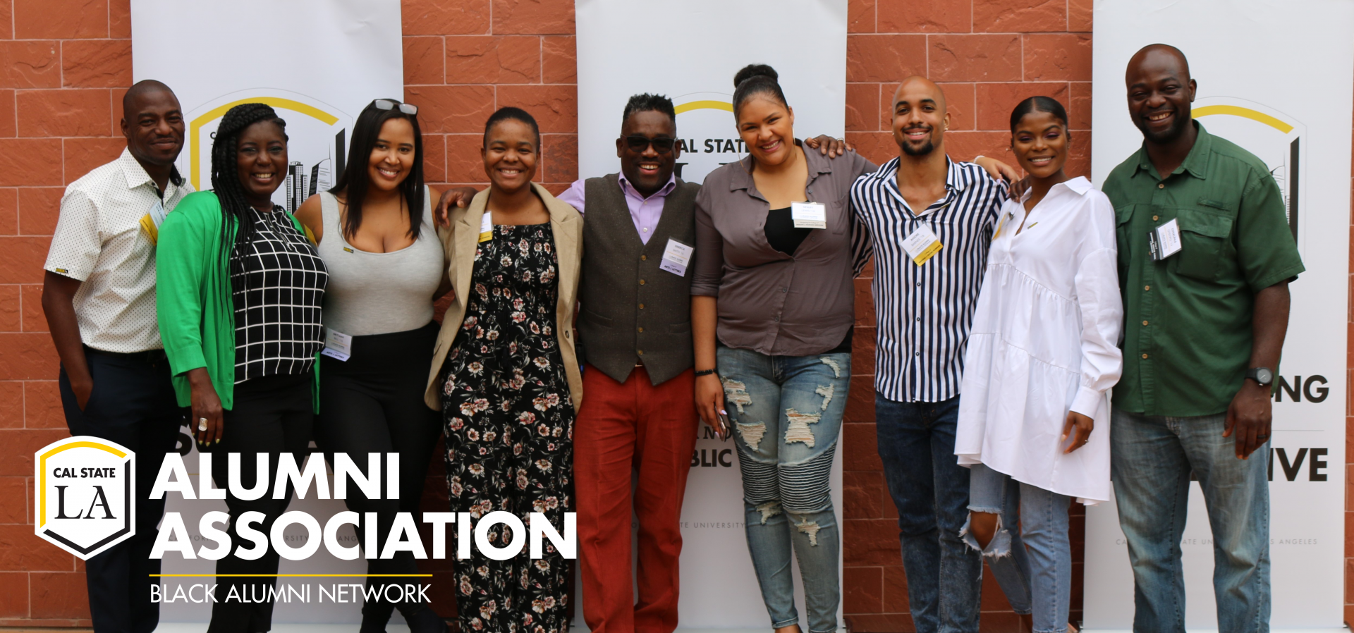 Members of the Black Alumni Network smiling and linking arms