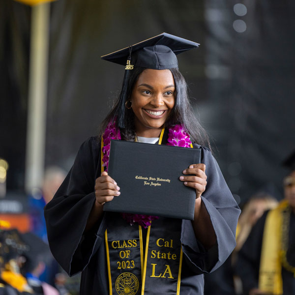 A student holds her diploma at graduation ceremony.