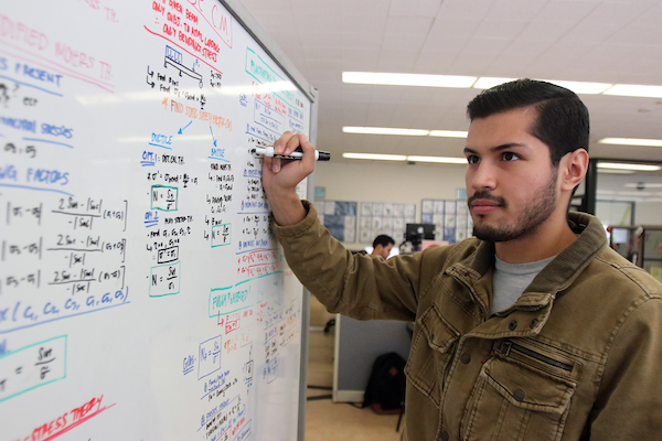 Student writing on a white board