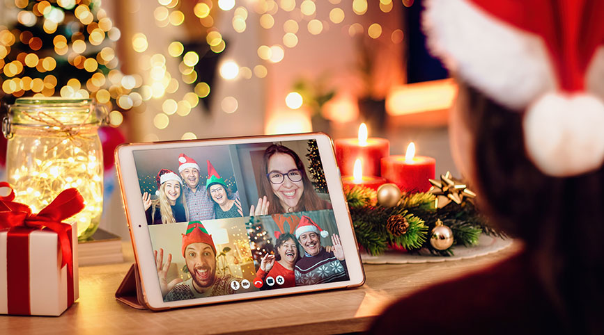 A person wearing a Santa hat in a Zoom gathering with other people