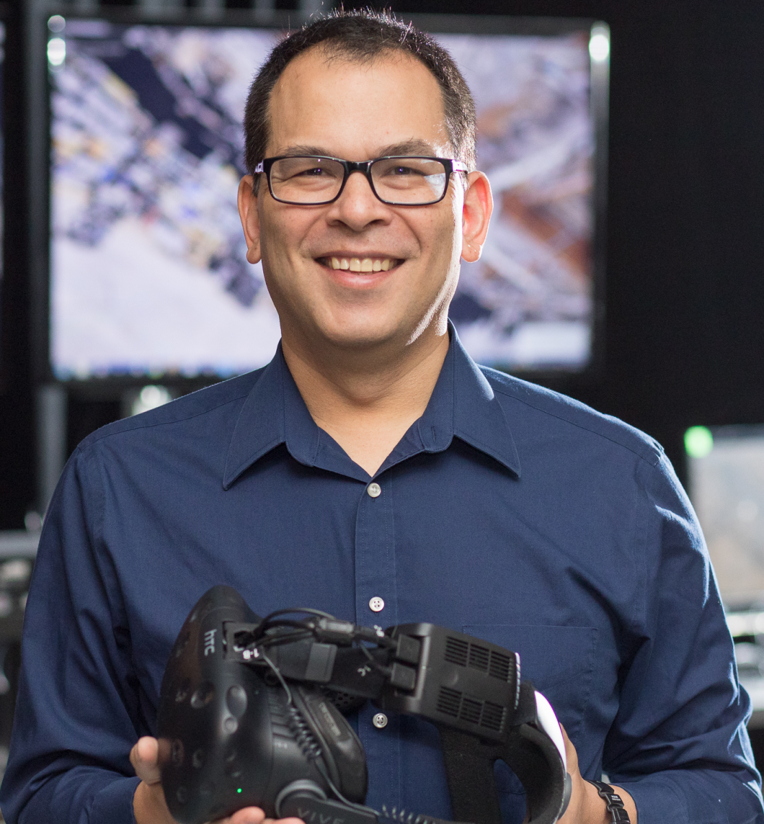 David Krum, Ph.D. a male faculty holding a head mount gear