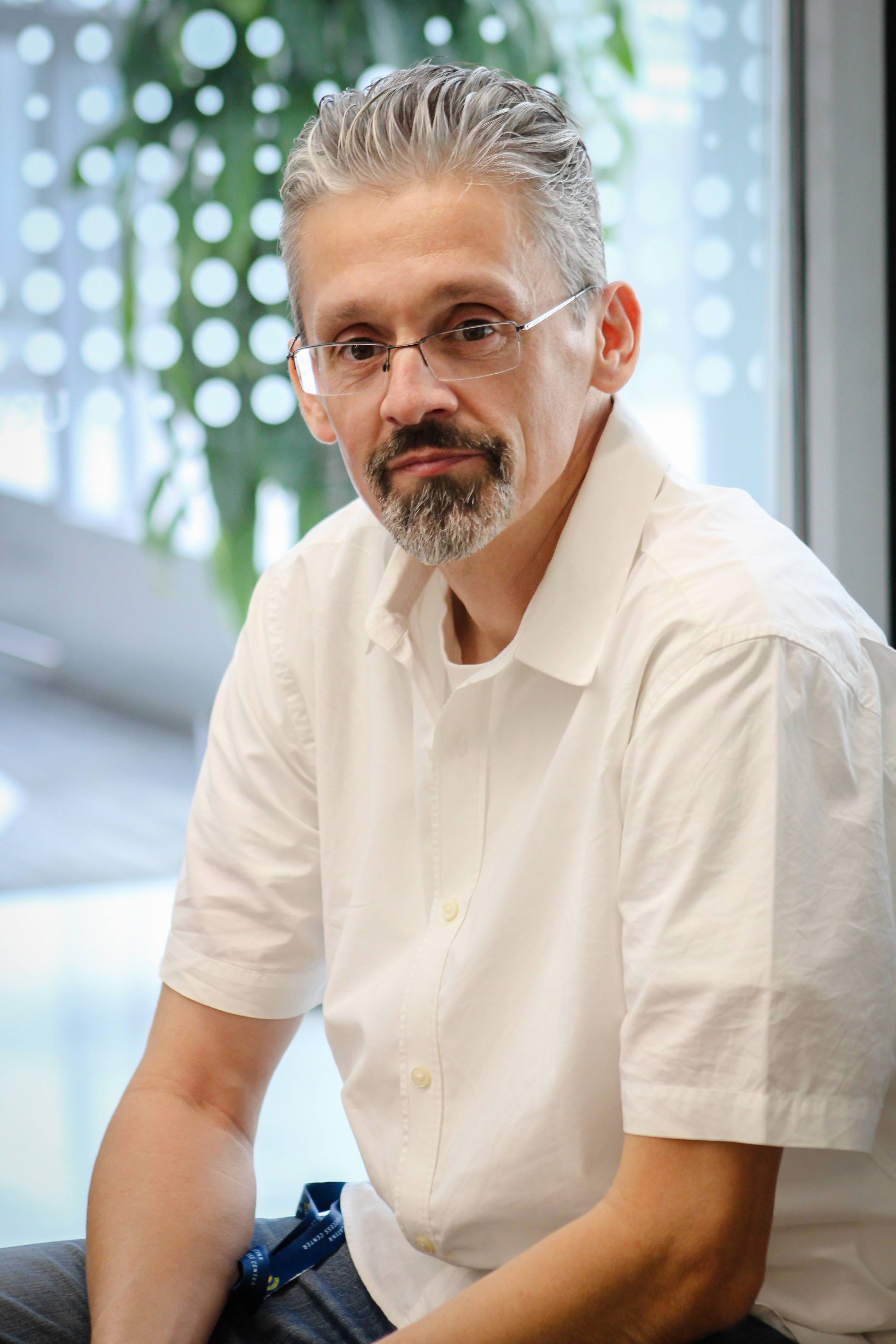 Marcos Pizarro posing for a picture sitting down