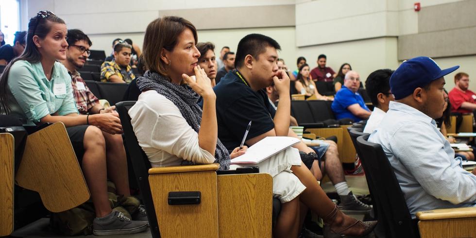 Students listening to orientation speakers in Rosser Hall lecture hall