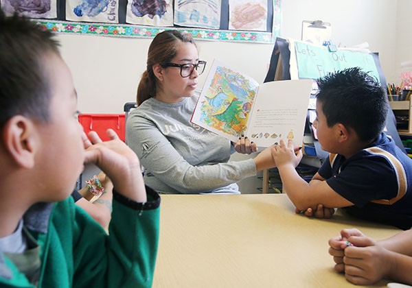 Student reading to children