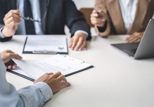 hands on table with resume and laptop