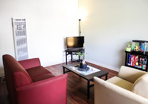 Living room with chairs, coffee table and television.