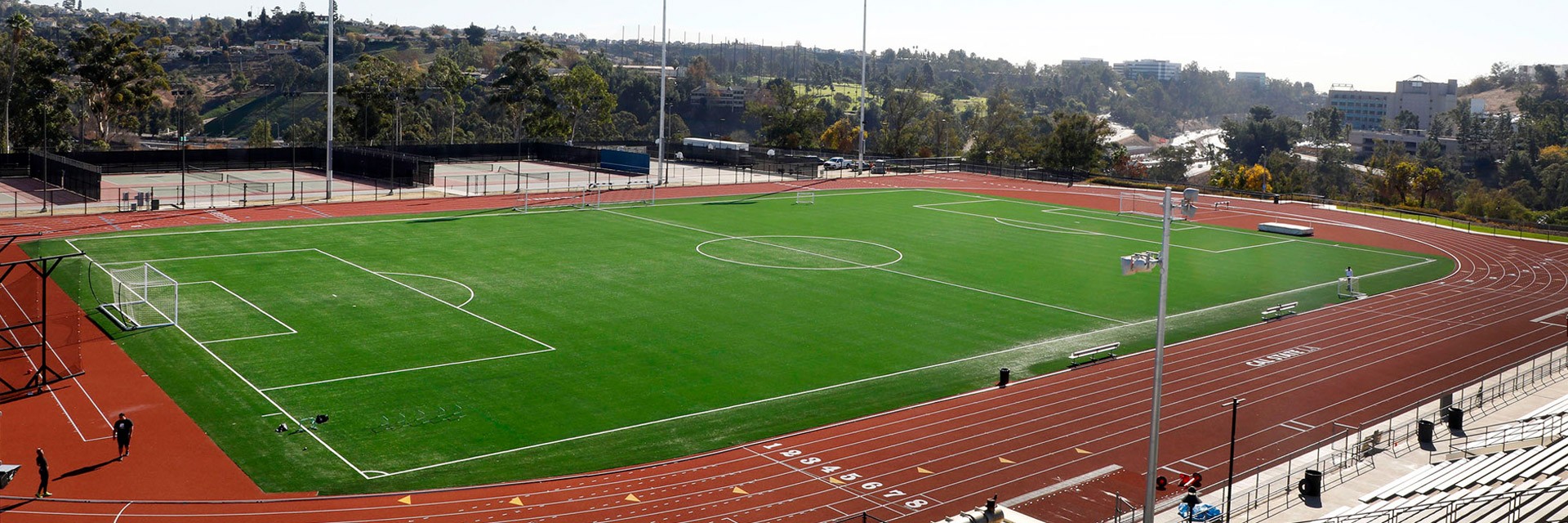 A track and field on a sunny day.