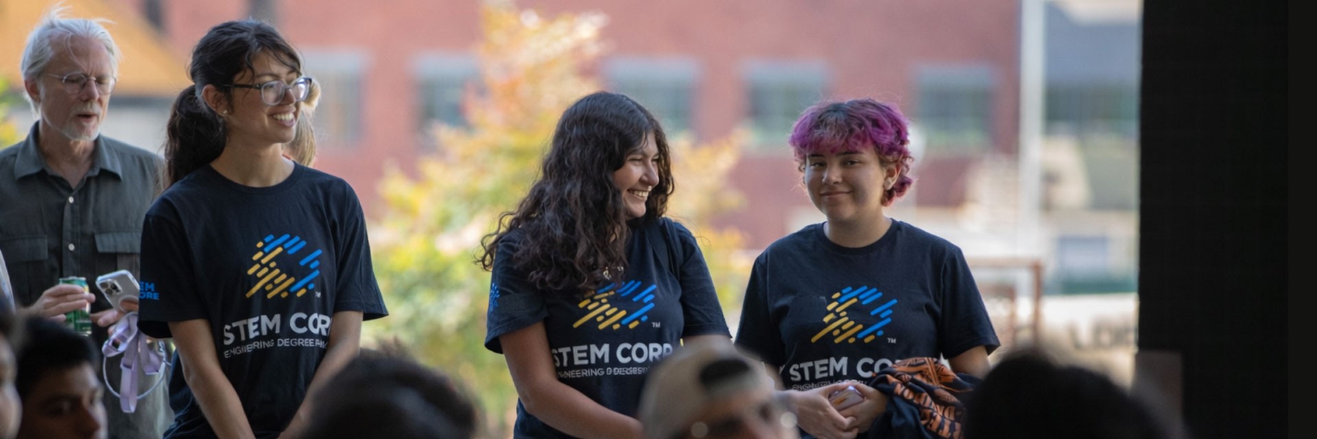 Students standing together, laughing.