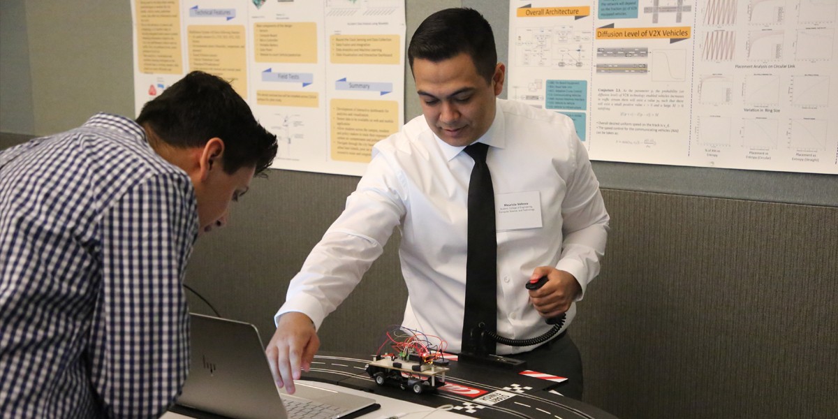 students work on track and computer for presentation