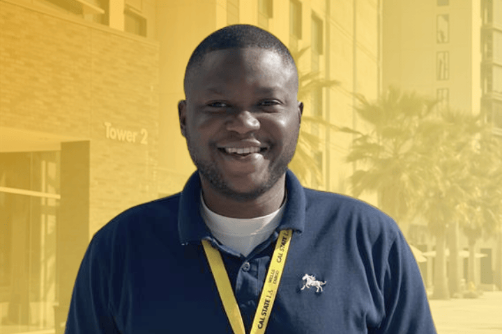 Cal State LA resident smiling in front of South Village.