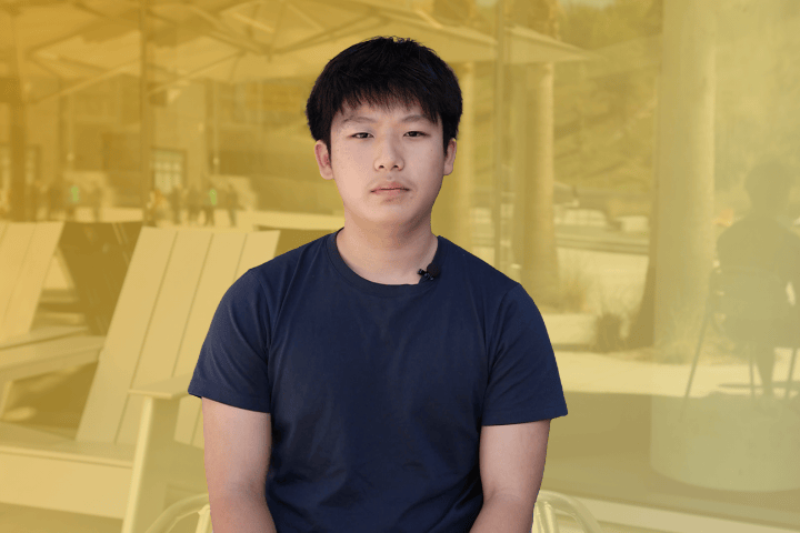 Cal State LA resident smiling in front of South Village.