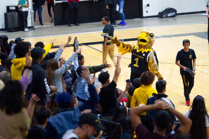 Students attending an exciting basketball game.