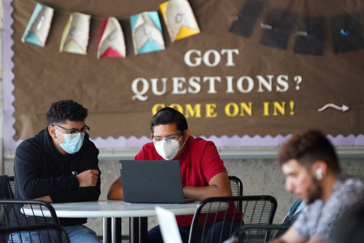 students with a got questions board on the background