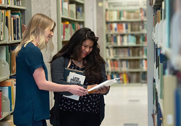 Two women looking over a book