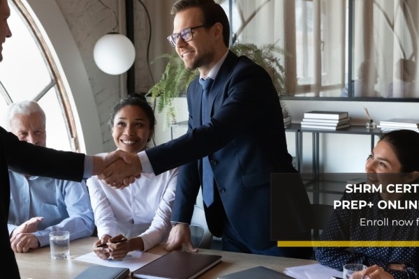 SHRM Logo. Two professionals shaking hands during a business meeting.