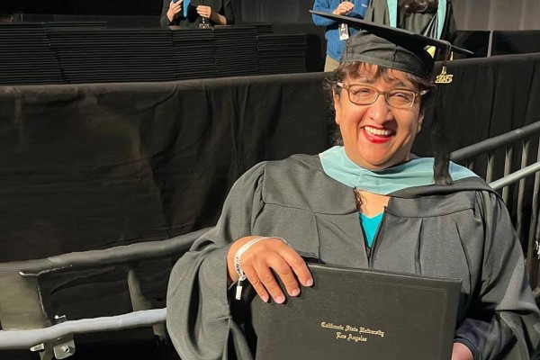 female graduate holding diploma