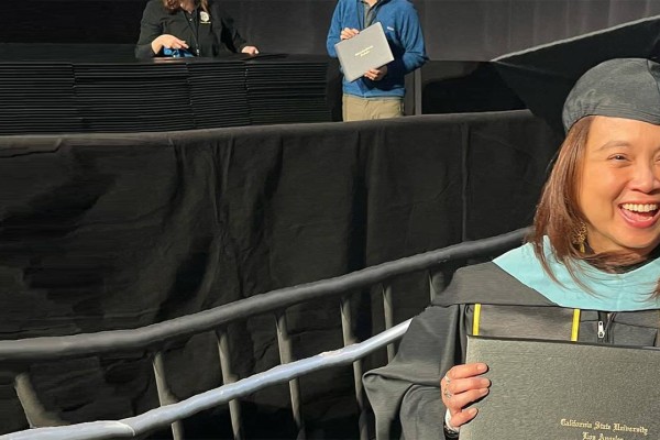 female graduate holding diploma