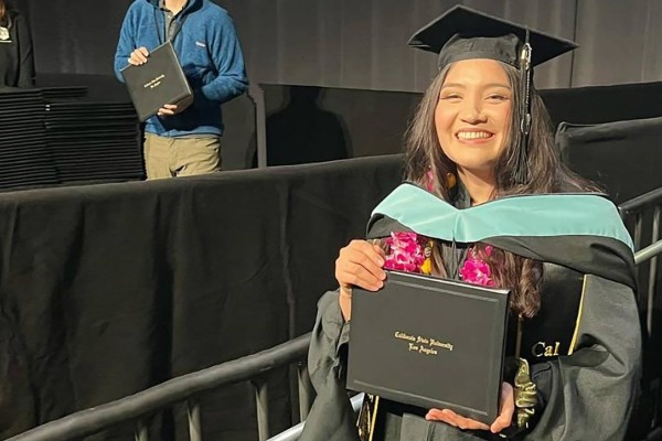 female graduate holding diploma