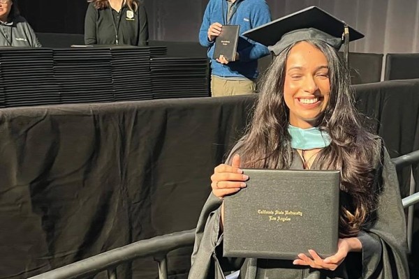 female graduate holding diploma