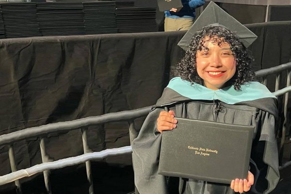 female graduate holding diploma