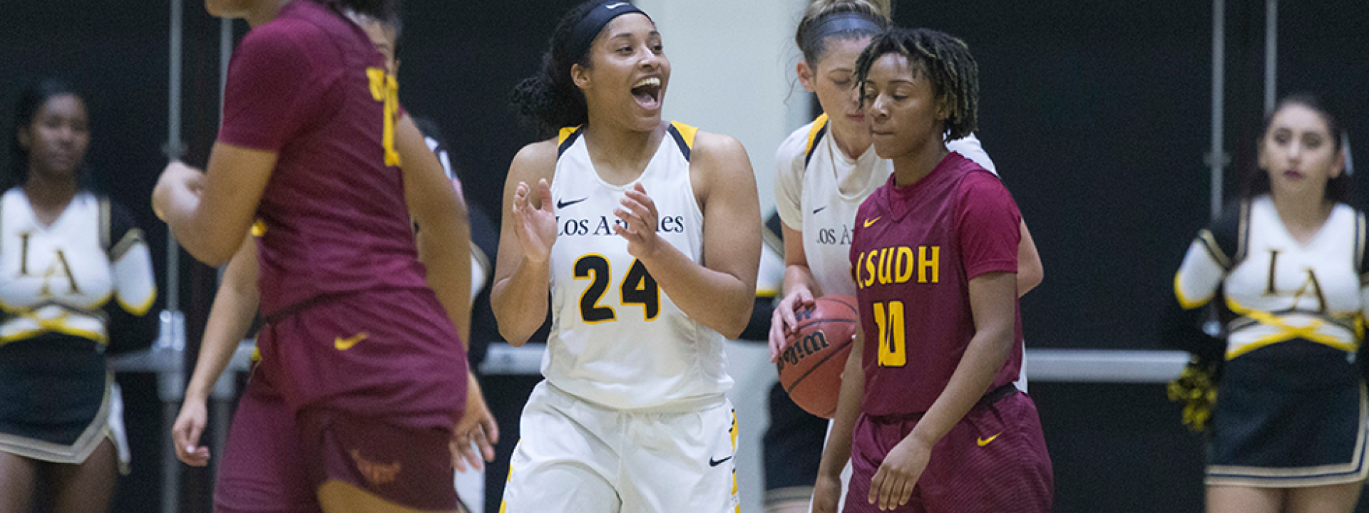 Image of the Cal State LA women's basketball team on the court mid-game. 