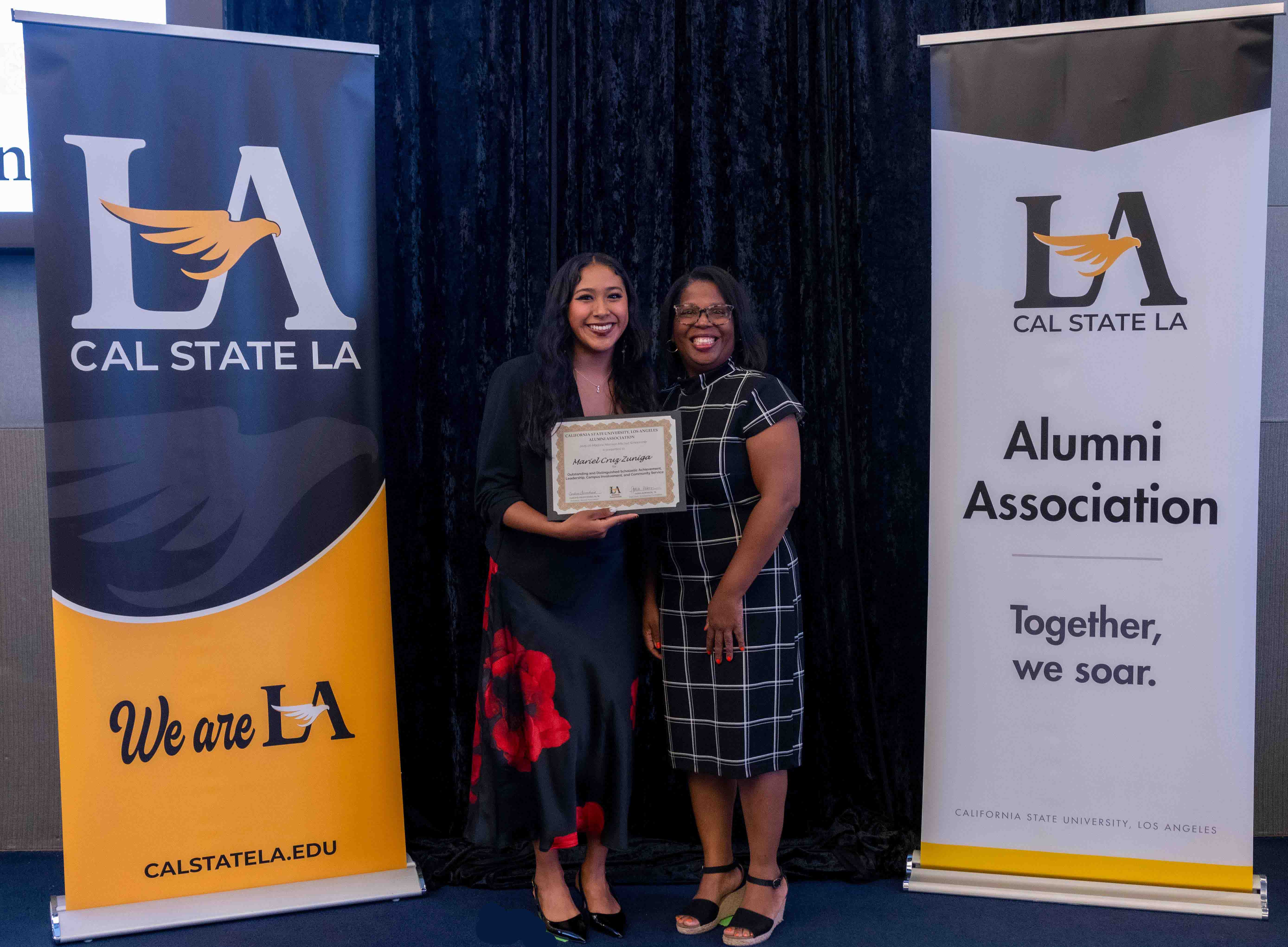 Tanea Robinson posing with a scholarship recipient